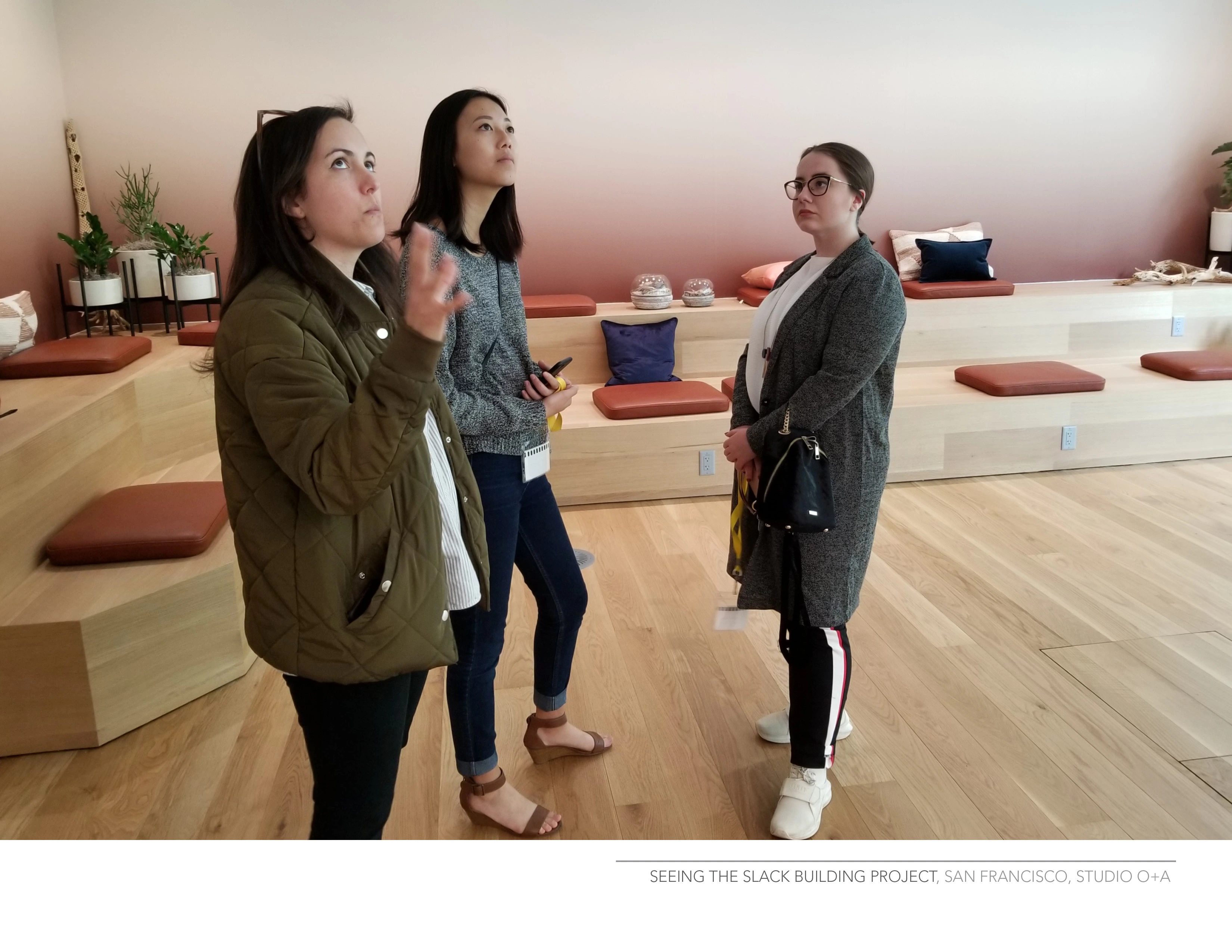 A natural shot of three women standing in a design open-space.