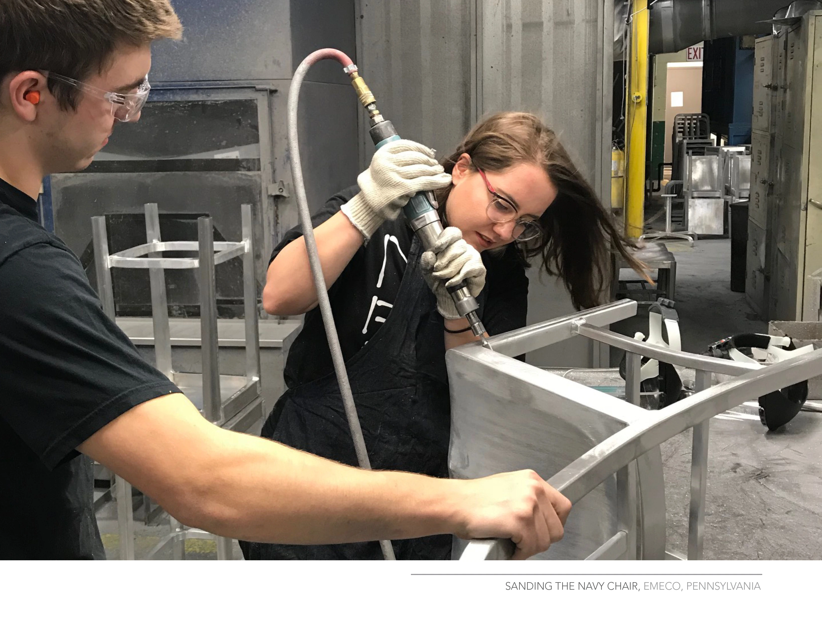 The main participant polishing an Emeco chair with a tool.